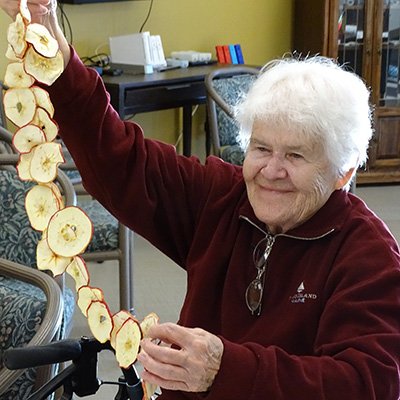 Sister Kathleen Denevan with string of apples